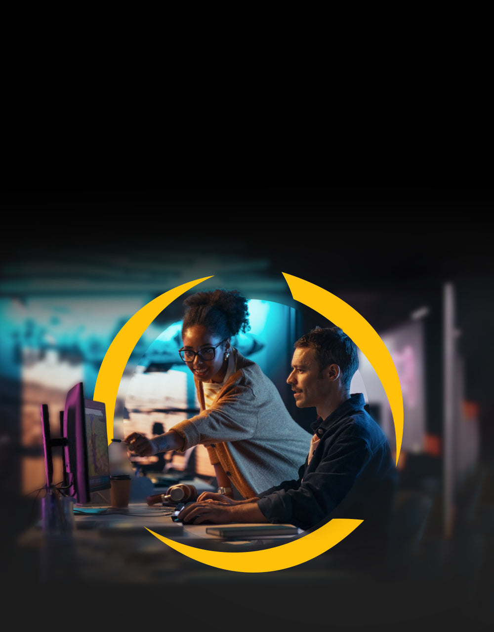 Two colleagues learning together at a computer.